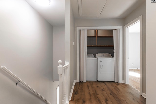 laundry room with dark hardwood / wood-style flooring and washing machine and clothes dryer