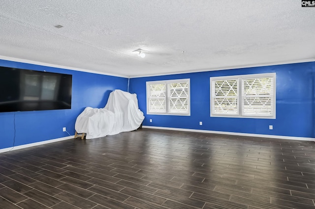unfurnished living room with a textured ceiling, a wealth of natural light, and baseboards