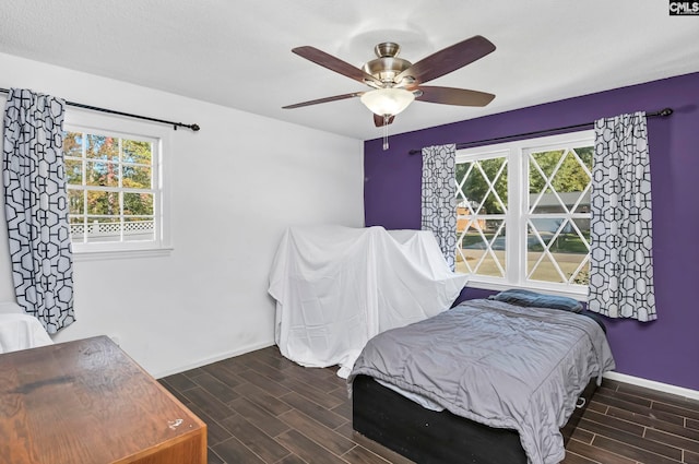 bedroom featuring ceiling fan, a textured ceiling, and dark hardwood / wood-style floors