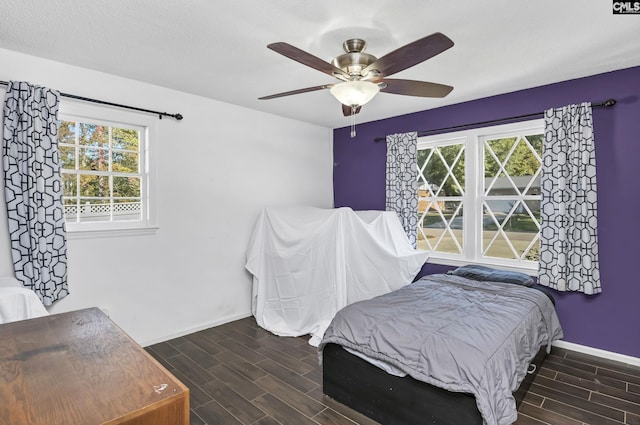 bedroom with wood tiled floor, ceiling fan, and baseboards