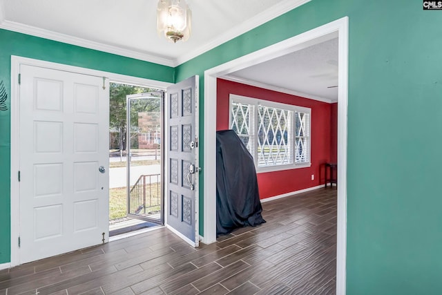 foyer featuring ornamental molding, dark wood-type flooring, and a healthy amount of sunlight