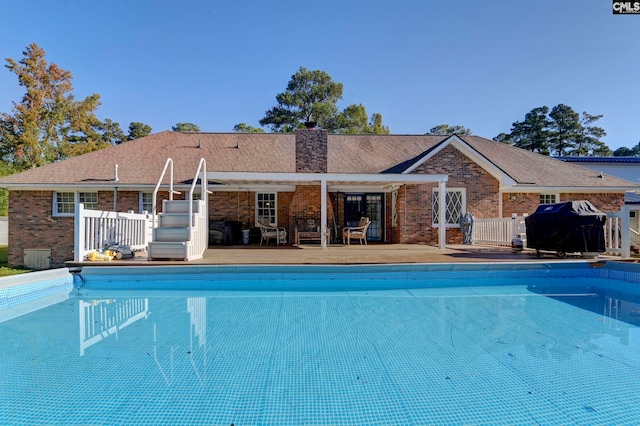 view of swimming pool featuring area for grilling and a patio