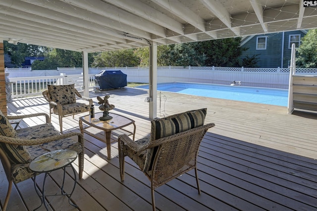 view of swimming pool featuring a fenced in pool, a deck, grilling area, and a fenced backyard