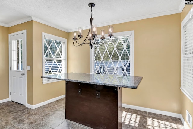 kitchen featuring ornamental molding, a textured ceiling, a chandelier, and hanging light fixtures