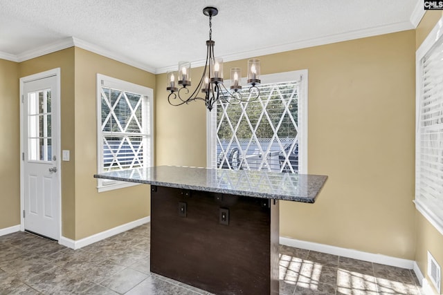 kitchen with a notable chandelier, stone counters, decorative light fixtures, baseboards, and ornamental molding