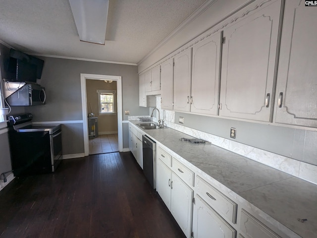 kitchen featuring dark hardwood / wood-style flooring, appliances with stainless steel finishes, white cabinetry, tile counters, and sink