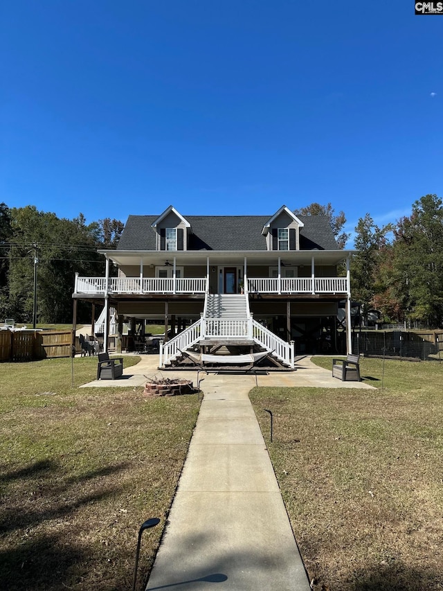 rear view of house featuring a patio and a yard