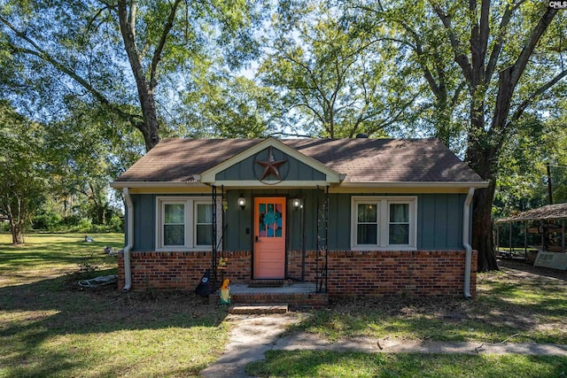 bungalow-style home with a front lawn