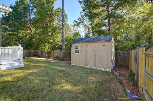 view of yard with a storage shed and a deck