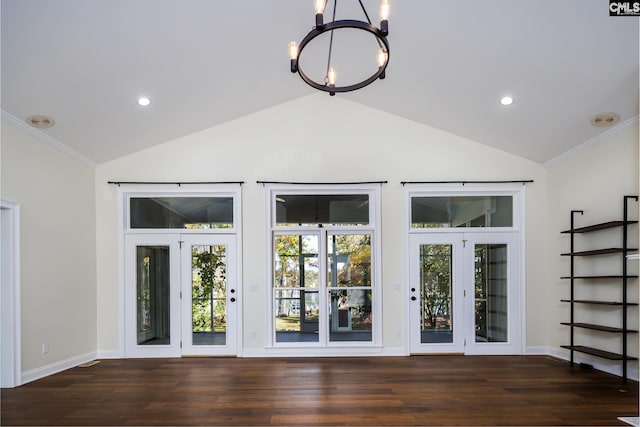 interior space with a notable chandelier, crown molding, vaulted ceiling, and dark hardwood / wood-style flooring