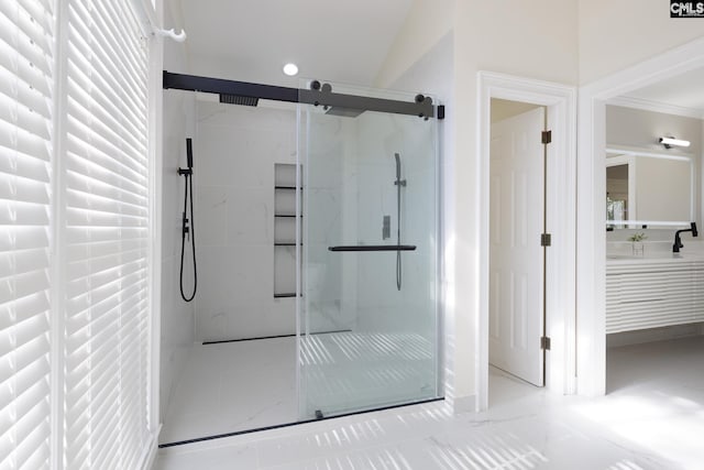 bathroom with vanity, crown molding, and walk in shower