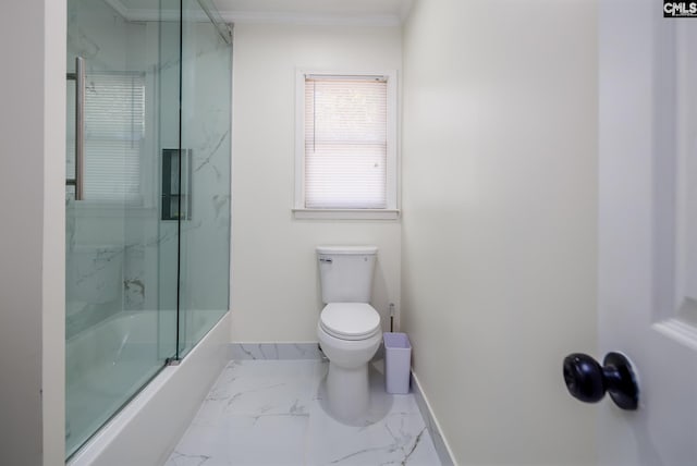 bathroom with crown molding, bath / shower combo with glass door, and toilet