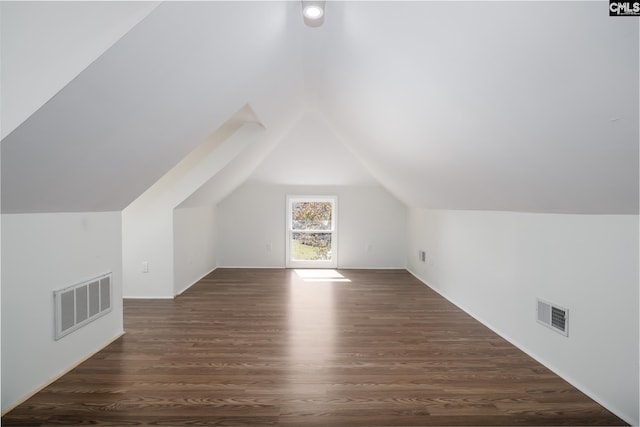 bonus room with lofted ceiling and dark wood-type flooring