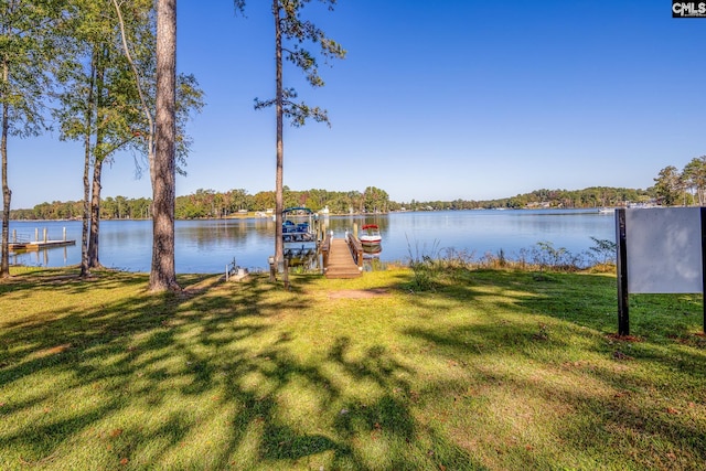 view of yard featuring a water view and a boat dock