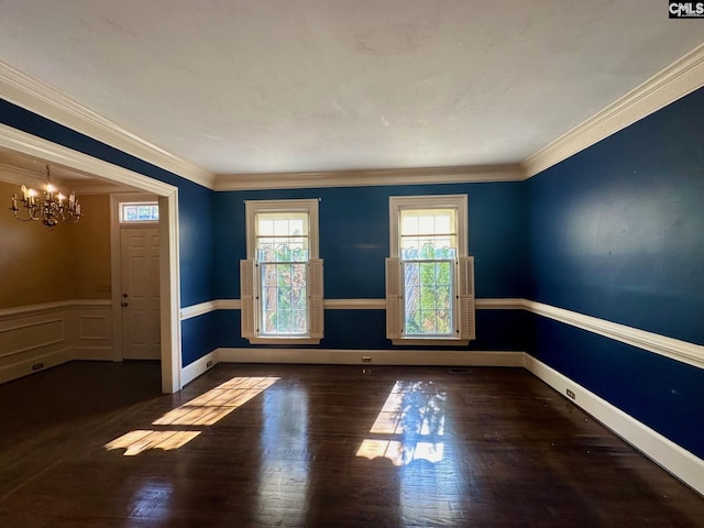 unfurnished room featuring ornamental molding, dark wood-type flooring, and a notable chandelier