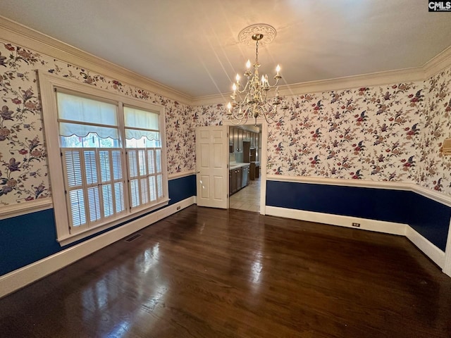 unfurnished dining area with crown molding, a notable chandelier, and dark hardwood / wood-style flooring