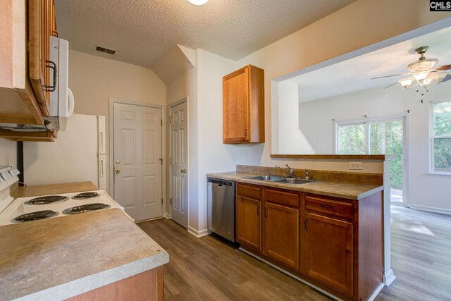 kitchen featuring hardwood / wood-style floors, a textured ceiling, sink, and white appliances