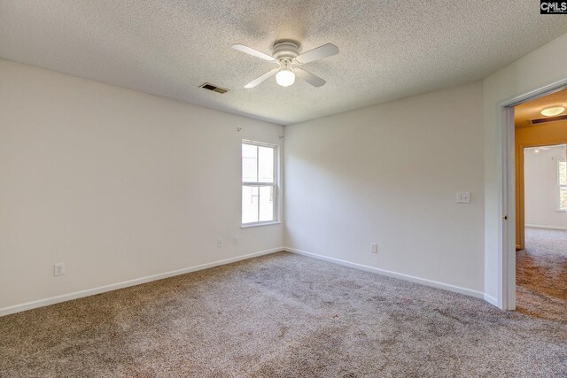 carpeted empty room with a textured ceiling and ceiling fan