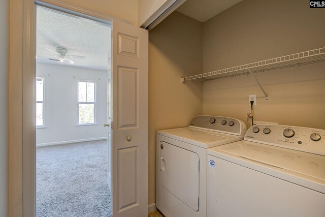 laundry room with light carpet, a textured ceiling, washing machine and clothes dryer, and ceiling fan