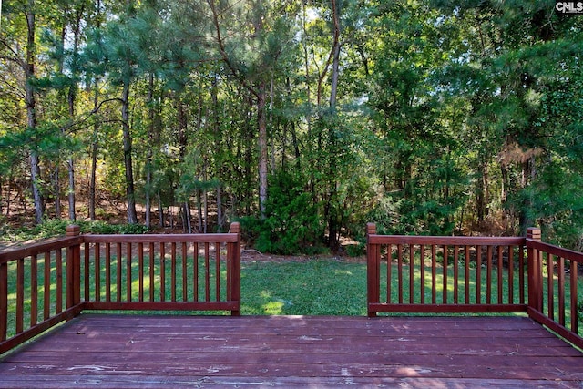 wooden deck with a lawn