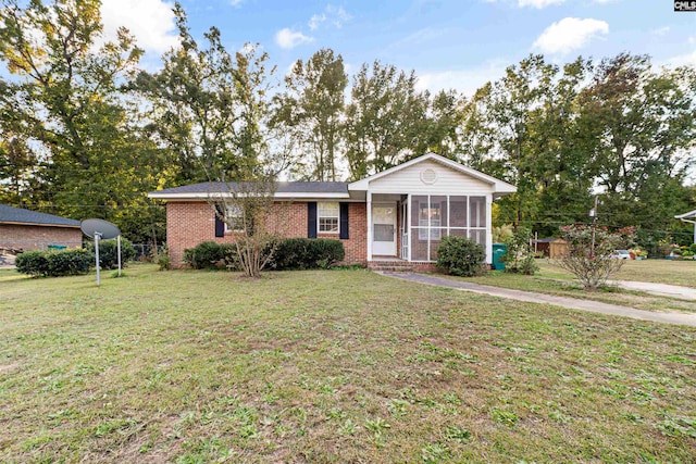 view of front of property with a front lawn and a sunroom