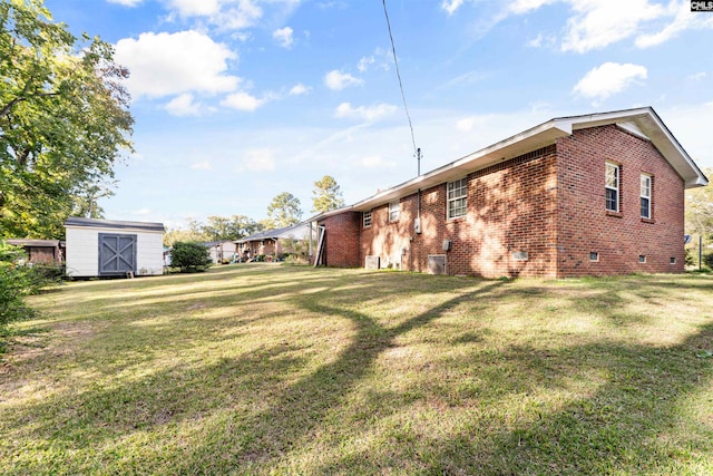 exterior space with a shed and a yard