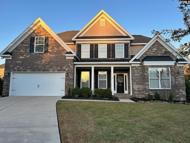 craftsman-style home with a front yard and a garage