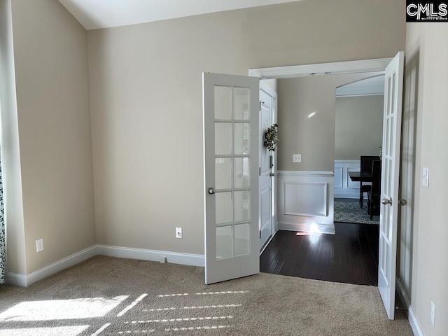 empty room with french doors and wood-type flooring