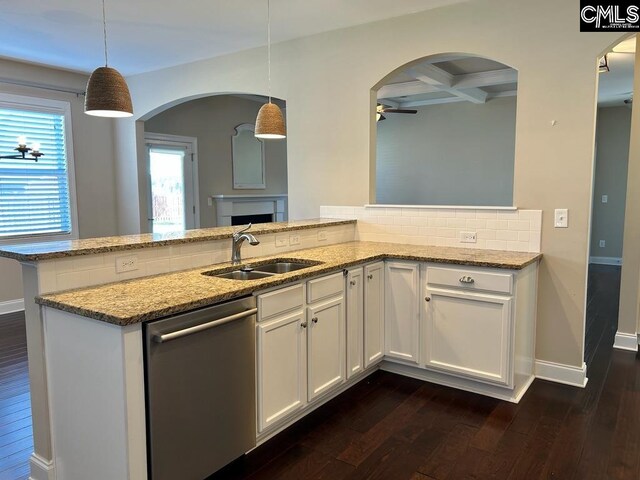 kitchen featuring decorative light fixtures, stainless steel dishwasher, white cabinets, light stone counters, and dark hardwood / wood-style flooring