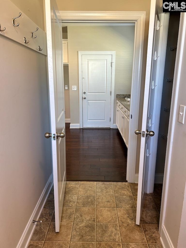 hallway with dark wood-type flooring