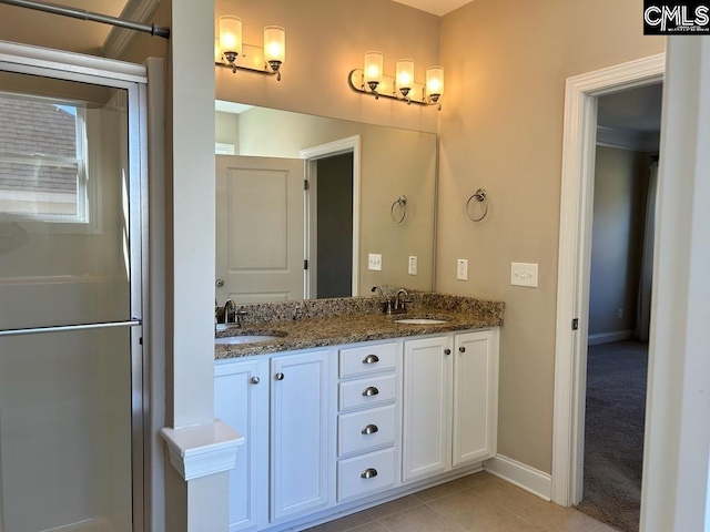 bathroom with vanity, an enclosed shower, and tile patterned floors