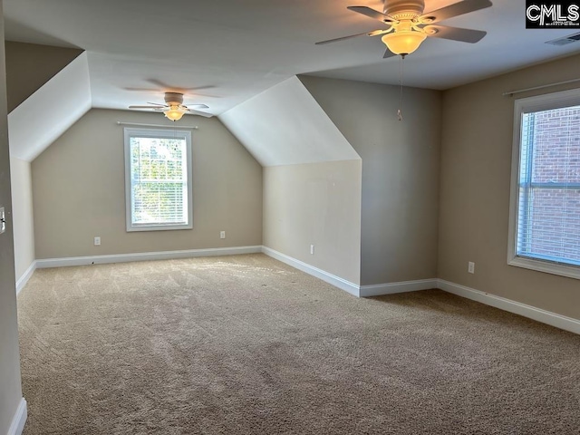 additional living space with lofted ceiling, light colored carpet, and ceiling fan