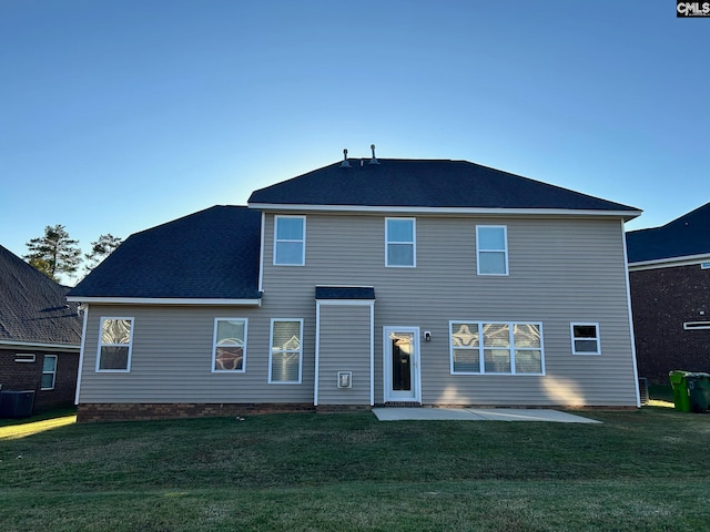 rear view of house featuring a patio and a lawn