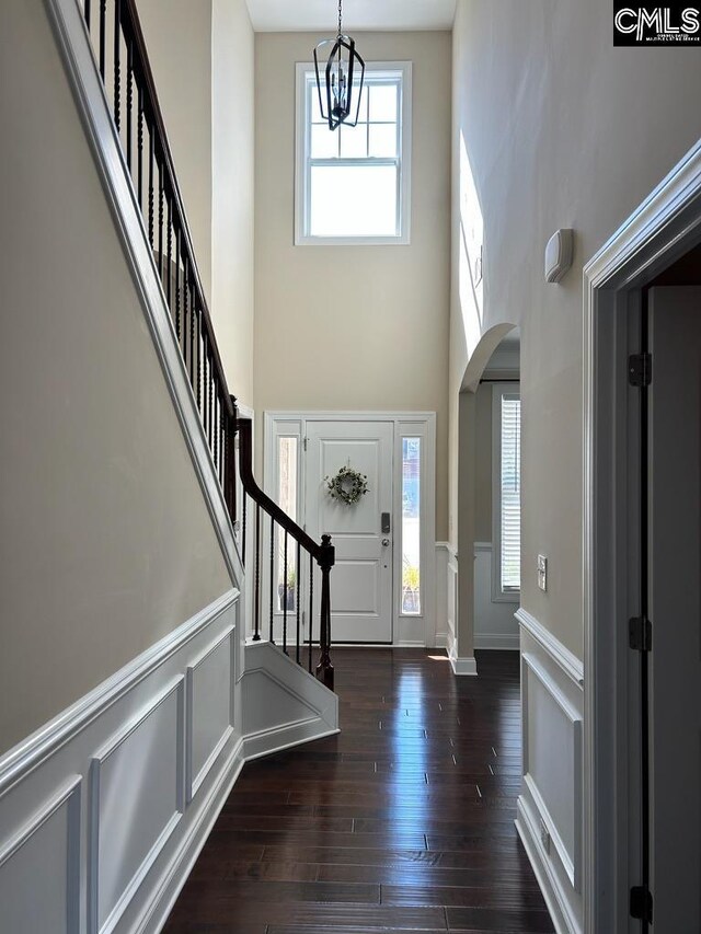 60 Fork Branch Ct, Irmo, SC 29063 - foyer featuring arched walkways, a high ceiling, stairway, a decorative wall, and wood-type flooring