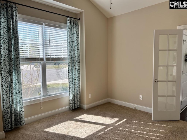 empty room with lofted ceiling and carpet floors