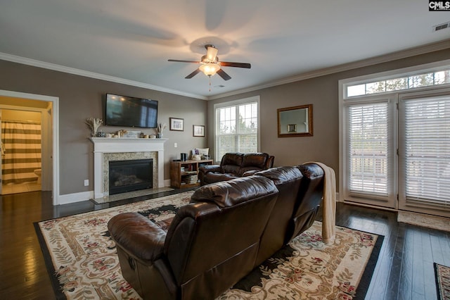 living room featuring dark wood-type flooring, ceiling fan, and crown molding