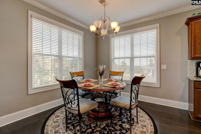 dining space with dark hardwood / wood-style floors, a healthy amount of sunlight, and crown molding