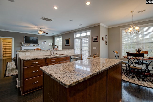 kitchen featuring hanging light fixtures, sink, and a kitchen island