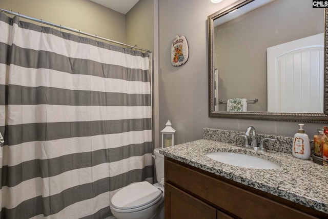 bathroom with vanity, toilet, and a shower with curtain