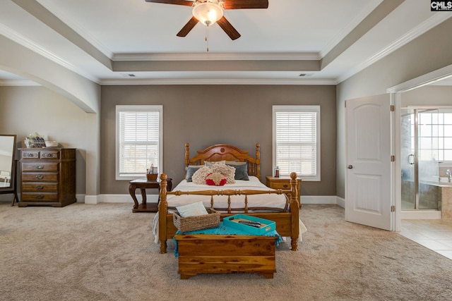 bedroom featuring crown molding, ensuite bath, multiple windows, and ceiling fan