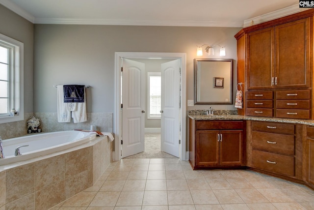 bathroom featuring tile patterned flooring, vanity, tiled tub, and ornamental molding