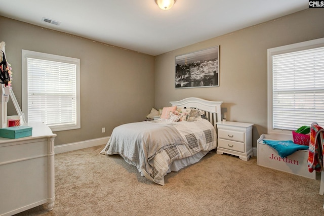 bedroom featuring light carpet