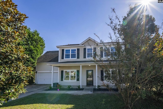 view of front facade featuring a porch, a garage, concrete driveway, and a front lawn