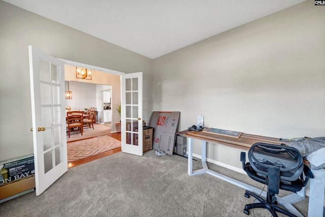 carpeted home office with french doors