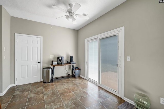interior space with ceiling fan and baseboards