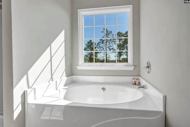 bathroom with a tub to relax in