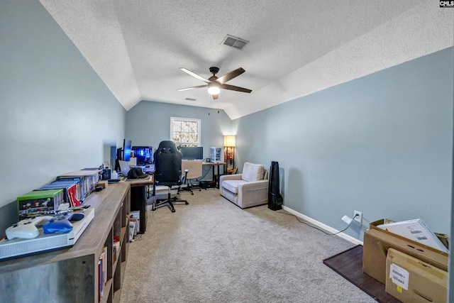 office space with visible vents, carpet floors, lofted ceiling, a textured ceiling, and a ceiling fan