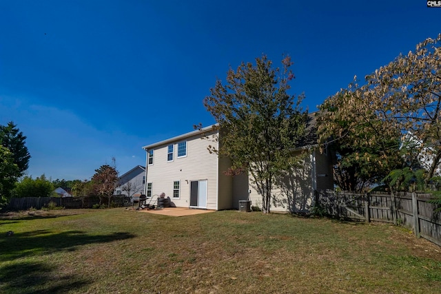 back of house with a patio area, central air condition unit, and a lawn