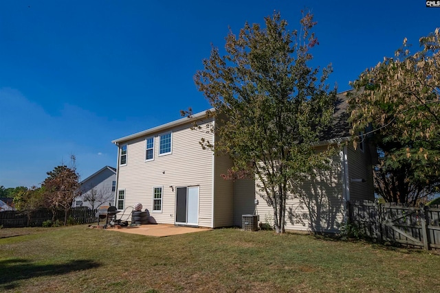 back of property with a patio, cooling unit, and a yard