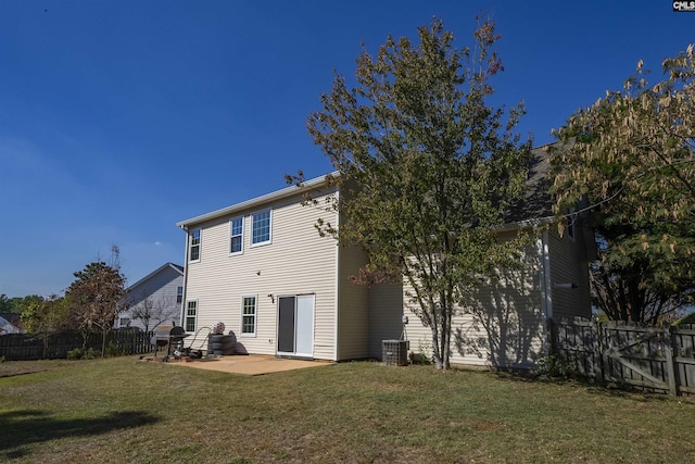 rear view of property featuring a fenced backyard, a patio, a yard, and central air condition unit